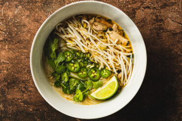 An overhead shot of a big bowl of pho