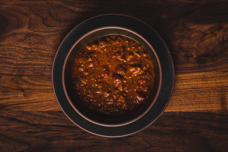 An overhead shot of a bowl of chili